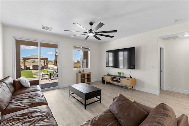 4030 Midnight Crest Ave, North Las Vegas, NV 89031 - living room featuring light wood-style flooring, a ceiling fan, and baseboards