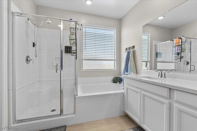 4030 Midnight Crest Ave, North Las Vegas, NV 89031 - bathroom with a shower stall, a garden tub, vanity, and wood finished floors