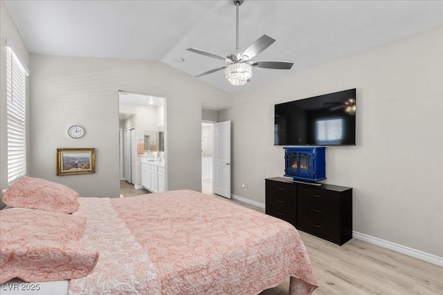 4030 Midnight Crest Ave, North Las Vegas, NV 89031 - bedroom with light wood-type flooring, vaulted ceiling, baseboards, a ceiling fan, and ensuite bathroom