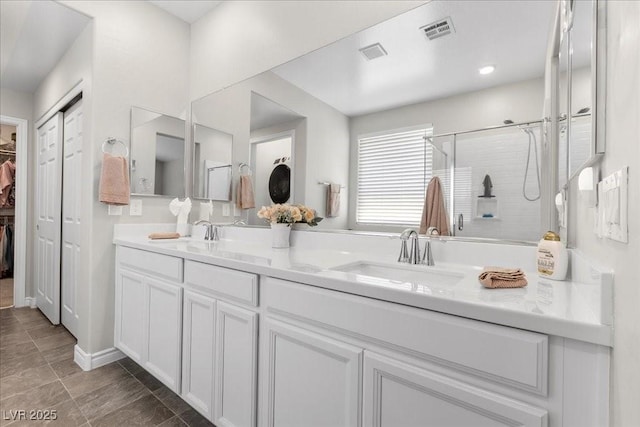 4030 Midnight Crest Ave, North Las Vegas, NV 89031 - bathroom with double vanity, a stall shower, and a walk in closet