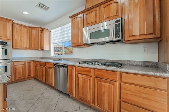 512 Los Dolces St, Las Vegas, NV 89138 - kitchen with stainless steel appliances, a sink, light tile patterned floors, and recessed lighting