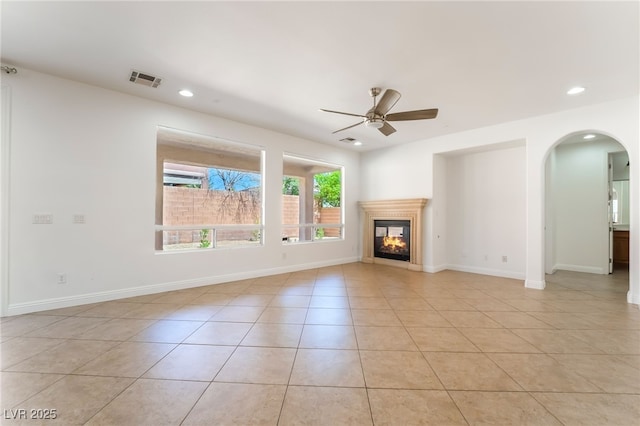 512 Los Dolces St, Las Vegas, NV 89138 - unfurnished living room featuring arched walkways, recessed lighting, ceiling fan, light tile patterned floors, and a multi sided fireplace