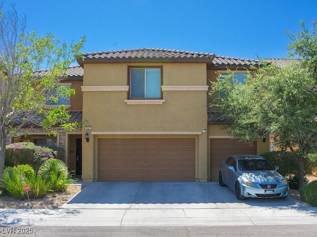 5507 Gemini Bridges St, Las Vegas, NV 89130 - view of front of home with an attached garage, stucco siding, a tile roof, and concrete driveway