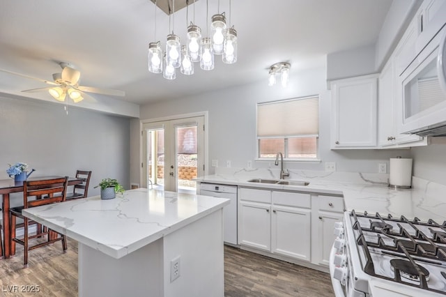 1073 Nordyke Ave, Henderson, NV 89015 - kitchen with a sink, white appliances, plenty of natural light, and a kitchen island