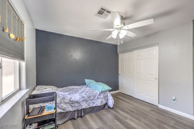 1073 Nordyke Ave, Henderson, NV 89015 - bedroom with wood finished floors, baseboards, a closet, and a ceiling fan