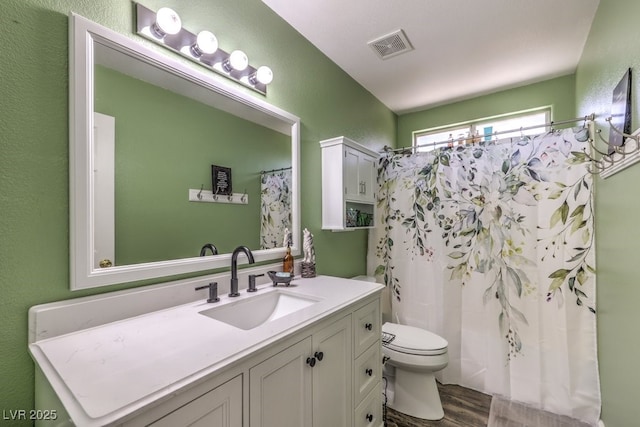 1073 Nordyke Ave, Henderson, NV 89015 - bathroom with toilet, wood finished floors, vanity, a textured wall, and curtained shower