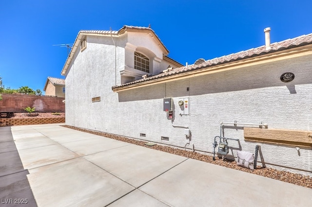 1073 Nordyke Ave, Henderson, NV 89015 - view of side of home featuring a patio area, stucco siding, and crawl space