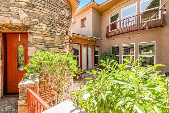 1737 Cypress Manor Dr, Henderson, NV 89012 - doorway to property with stone siding, stucco siding, and a balcony