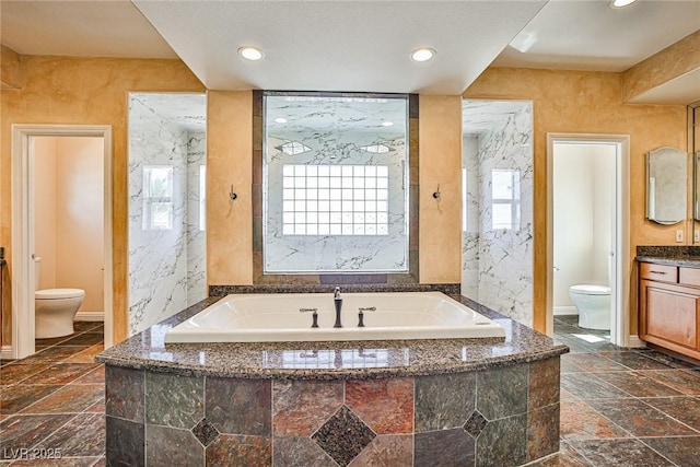 1737 Cypress Manor Dr, Henderson, NV 89012 - full bathroom featuring toilet, a bath, vanity, recessed lighting, and baseboards