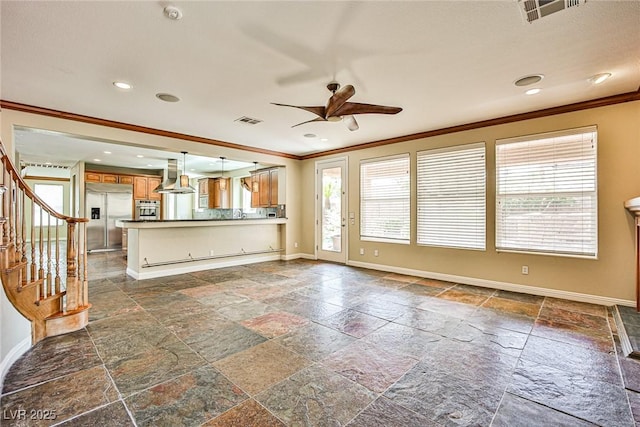 1737 Cypress Manor Dr, Henderson, NV 89012 - unfurnished living room with stone tile floors, crown molding, baseboards, ceiling fan, and recessed lighting