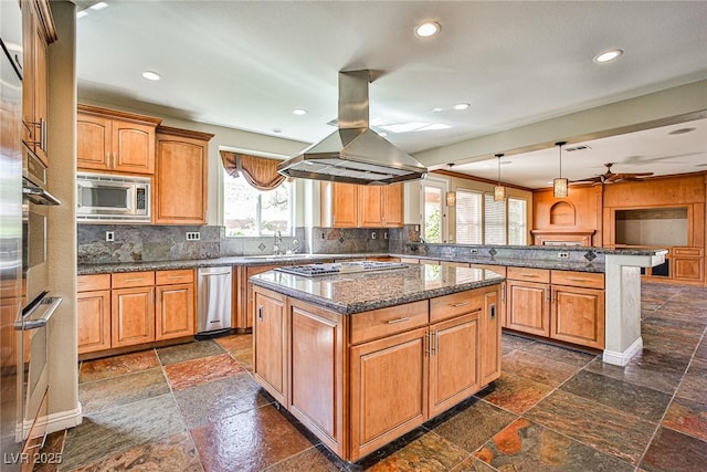 1737 Cypress Manor Dr, Henderson, NV 89012 - kitchen featuring stainless steel appliances, island range hood, a peninsula, stone tile flooring, and a center island