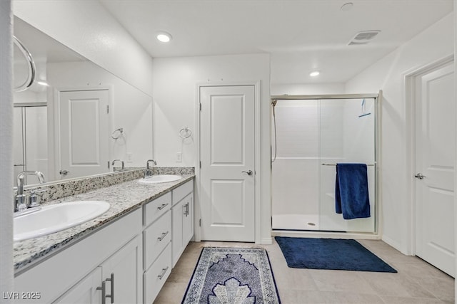 392 Canary Song Dr, Henderson, NV 89011 - full bath featuring a stall shower, double vanity, and tile patterned flooring