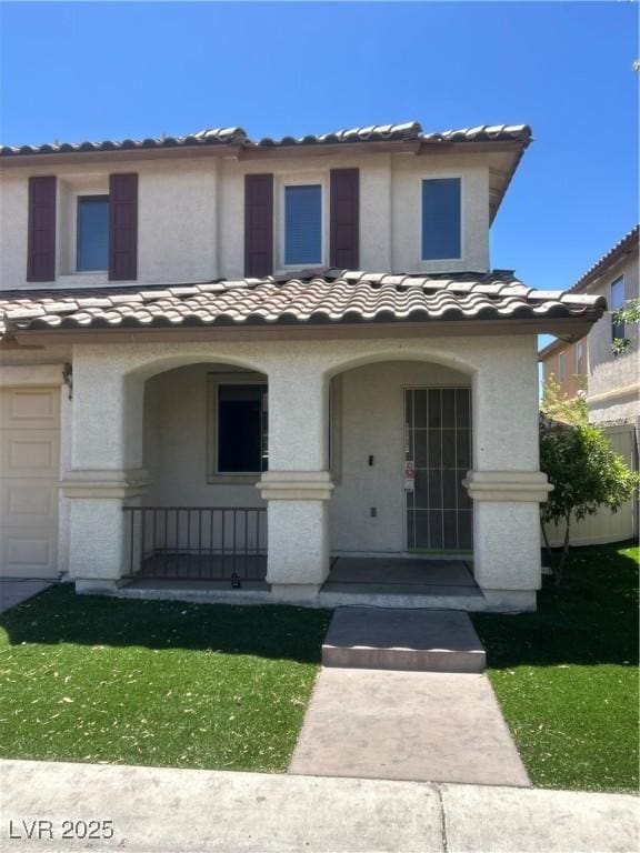 1069 Coronado Peak Ave, Las Vegas, NV 89183 - view of front facade with a tile roof, a porch, a garage, and stucco siding