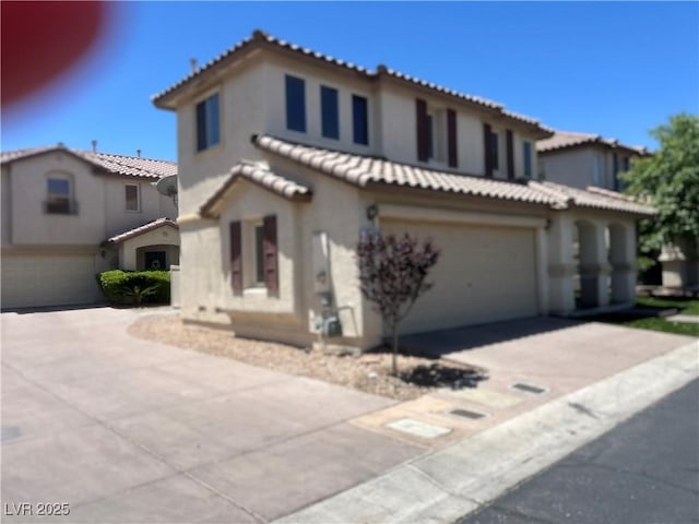 1069 Coronado Peak Ave, Las Vegas, NV 89183 - mediterranean / spanish-style home with a garage, concrete driveway, a tile roof, and stucco siding
