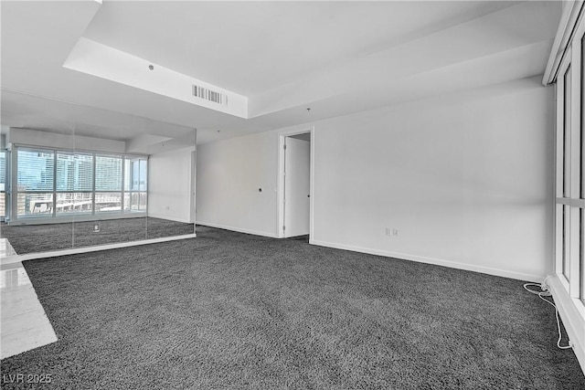 4525 Dean Martin Dr Unit 909, Las Vegas, NV 89103 - unfurnished room with dark colored carpet and a raised ceiling