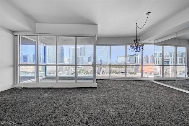 4525 Dean Martin Dr Unit 909, Las Vegas, NV 89103 - carpeted spare room with healthy amount of natural light, a chandelier, and a skyline view