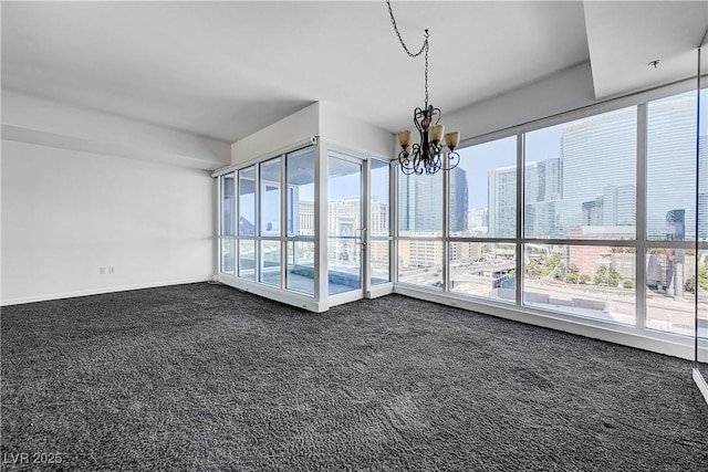 4525 Dean Martin Dr Unit 909, Las Vegas, NV 89103 - spare room with dark carpet and a chandelier