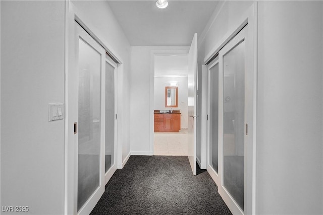 4525 Dean Martin Dr Unit 909, Las Vegas, NV 89103 - hall featuring dark carpet and baseboards