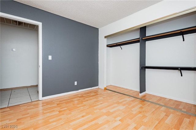4205 Thicket Ave, North Las Vegas, NV 89031 - unfurnished bedroom featuring wood finished floors, baseboards, and a textured ceiling
