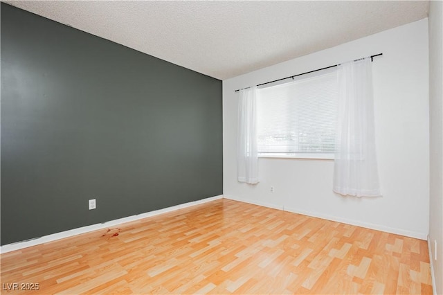 4205 Thicket Ave, North Las Vegas, NV 89031 - spare room featuring wood finished floors, baseboards, and a textured ceiling