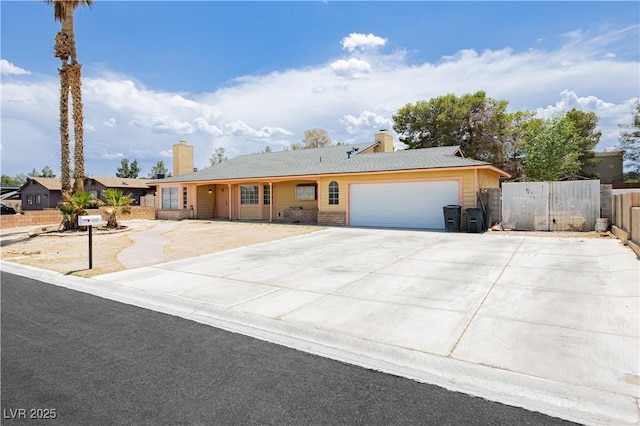 4205 Thicket Ave, North Las Vegas, NV 89031 - ranch-style home with a chimney, an attached garage, and driveway