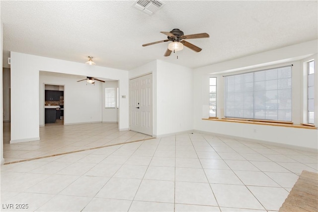 4205 Thicket Ave, North Las Vegas, NV 89031 - unfurnished room with a ceiling fan, a textured ceiling, light tile patterned floors, and baseboards