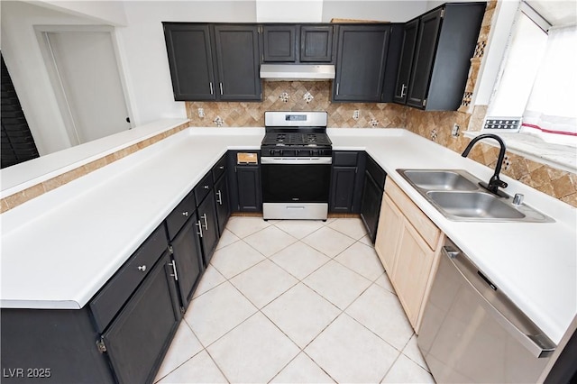4205 Thicket Ave, North Las Vegas, NV 89031 - kitchen featuring stainless steel appliances, a sink, under cabinet range hood, decorative backsplash, and light countertops