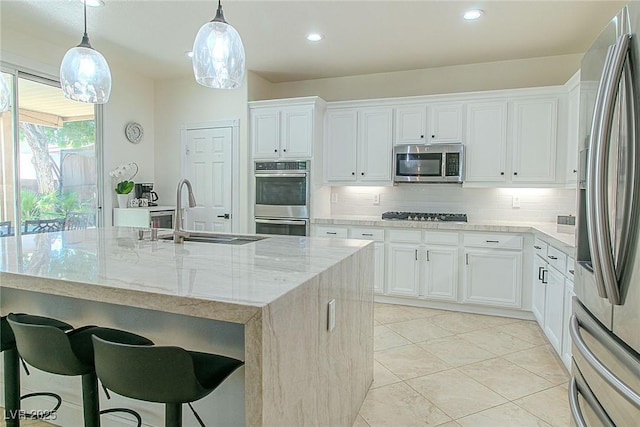 10744 Balsam Creek Ave, Las Vegas, NV 89144 - kitchen with appliances with stainless steel finishes, a sink, tasteful backsplash, light stone counters, and recessed lighting