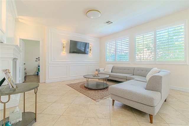 10744 Balsam Creek Ave, Las Vegas, NV 89144 - living room with a decorative wall, light tile patterned floors, and baseboards