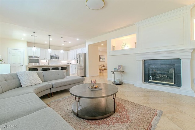 10744 Balsam Creek Ave, Las Vegas, NV 89144 - living room with recessed lighting, light tile patterned floors, a tile fireplace, and baseboards