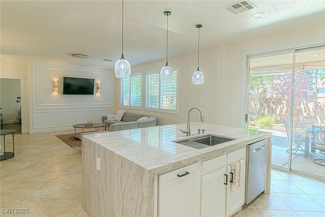 10744 Balsam Creek Ave, Las Vegas, NV 89144 - kitchen with a sink, dishwasher, light stone counters, an island with sink, and a decorative wall