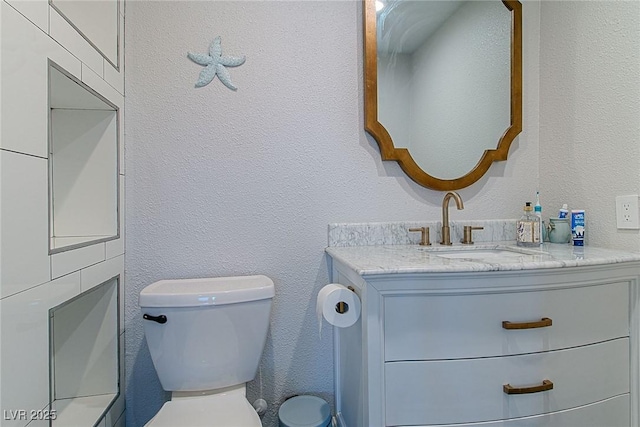 10744 Balsam Creek Ave, Las Vegas, NV 89144 - bathroom featuring vanity, toilet, and a textured wall