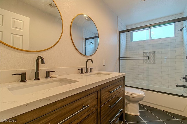 10744 Balsam Creek Ave, Las Vegas, NV 89144 - full bathroom featuring double vanity, toilet, bath / shower combo with glass door, and tile patterned floors