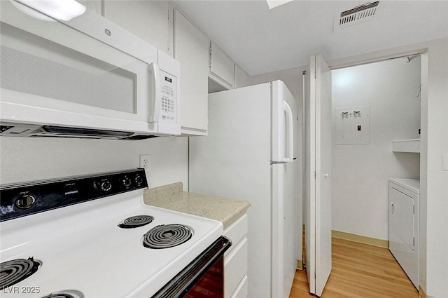 8600 W Charleston Blvd Unit 1128, Las Vegas, NV 89117 - kitchen featuring white appliances, washer / dryer, light wood-style flooring, light countertops, and white cabinetry