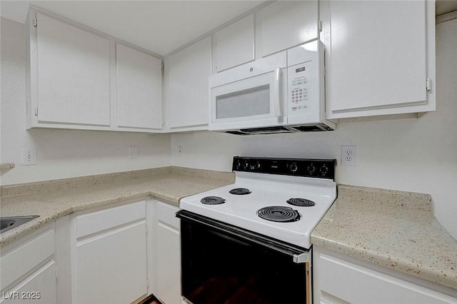 8600 W Charleston Blvd Unit 1128, Las Vegas, NV 89117 - kitchen with electric range oven, white microwave, white cabinetry, and light countertops
