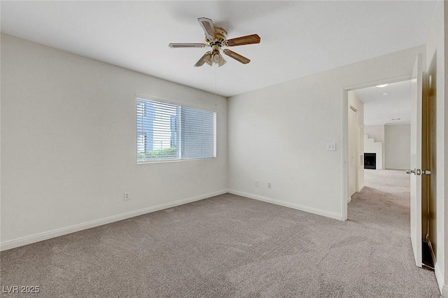8600 W Charleston Blvd Unit 1128, Las Vegas, NV 89117 - empty room with ceiling fan, carpet, a fireplace, and baseboards