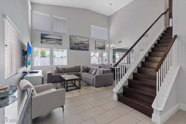 600 Beresford Ave, Las Vegas, NV 89123 - living area featuring high vaulted ceiling, stairs, plenty of natural light, and light tile patterned flooring