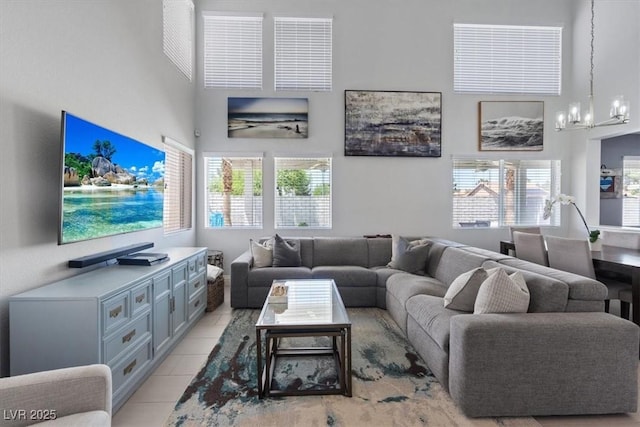 600 Beresford Ave, Las Vegas, NV 89123 - living room featuring a high ceiling, a chandelier, healthy amount of natural light, and light tile patterned flooring