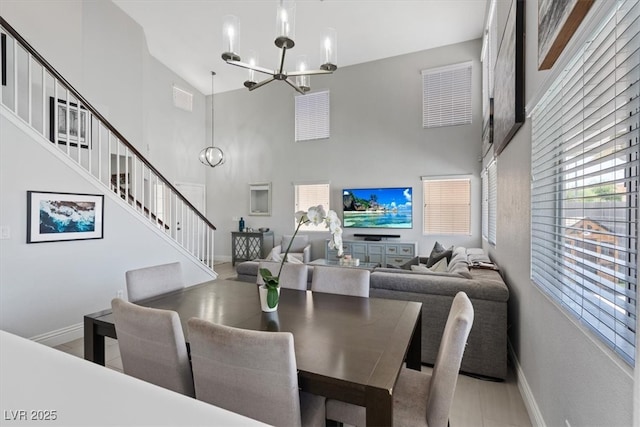 600 Beresford Ave, Las Vegas, NV 89123 - dining space with a high ceiling, a chandelier, baseboards, and stairway