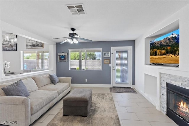 600 Beresford Ave, Las Vegas, NV 89123 - living room featuring light tile patterned floors, a ceiling fan, and a fireplace