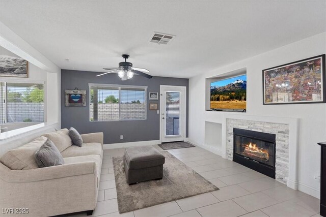 600 Beresford Ave, Las Vegas, NV 89123 - living area featuring a ceiling fan, a stone fireplace, and tile patterned flooring