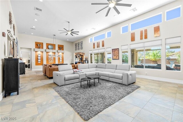 7504 Frittata Ave, Las Vegas, NV 89113 - living room featuring ceiling fan, a high ceiling, baseboards, and recessed lighting