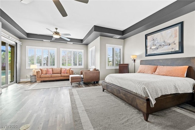 7504 Frittata Ave, Las Vegas, NV 89113 - bedroom with access to outside, a raised ceiling, wood finished floors, baseboards, and a ceiling fan