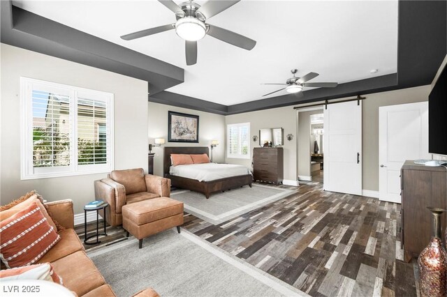 7504 Frittata Ave, Las Vegas, NV 89113 - bedroom with baseboards, dark wood finished floors, a tray ceiling, and a barn door