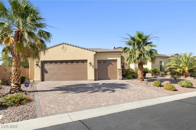 7504 Frittata Ave, Las Vegas, NV 89113 - view of front of house with stucco siding, an attached garage, decorative driveway, and a tiled roof