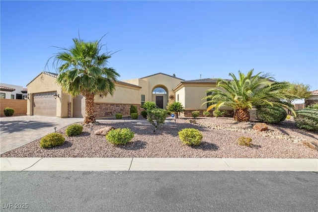 7504 Frittata Ave, Las Vegas, NV 89113 - mediterranean / spanish-style house with driveway, stone siding, and stucco siding