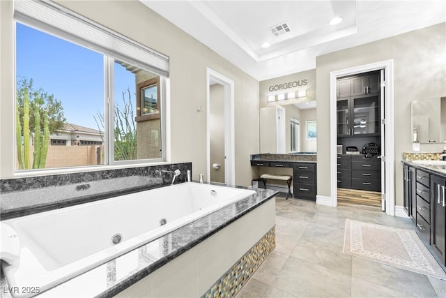 7504 Frittata Ave, Las Vegas, NV 89113 - full bath featuring vanity, a jetted tub, recessed lighting, and a tray ceiling