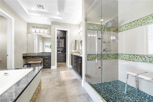7504 Frittata Ave, Las Vegas, NV 89113 - full bathroom featuring a stall shower, vanity, a garden tub, tile patterned flooring, and a tray ceiling