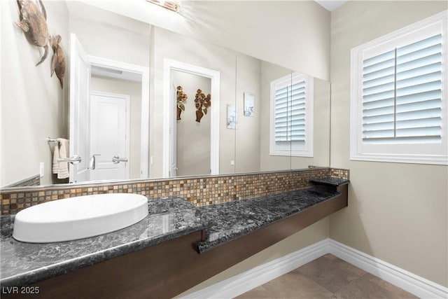 7504 Frittata Ave, Las Vegas, NV 89113 - bathroom featuring backsplash and baseboards