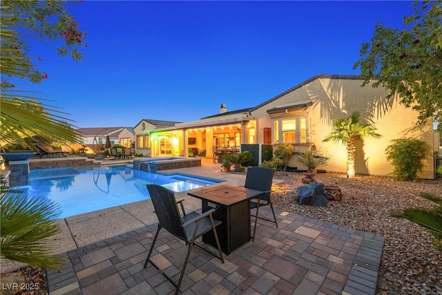 7504 Frittata Ave, Las Vegas, NV 89113 - view of swimming pool featuring a patio, outdoor dining space, and a pool with connected hot tub
